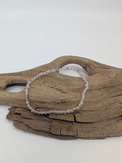 3 mm Super Seven bracelet showing clear and smoky quartz beads