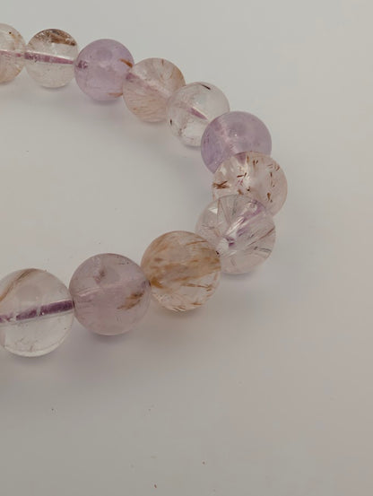 Close-up of 8MM Super Seven bracelet highlighting rutile and lepidocrocite inclusions