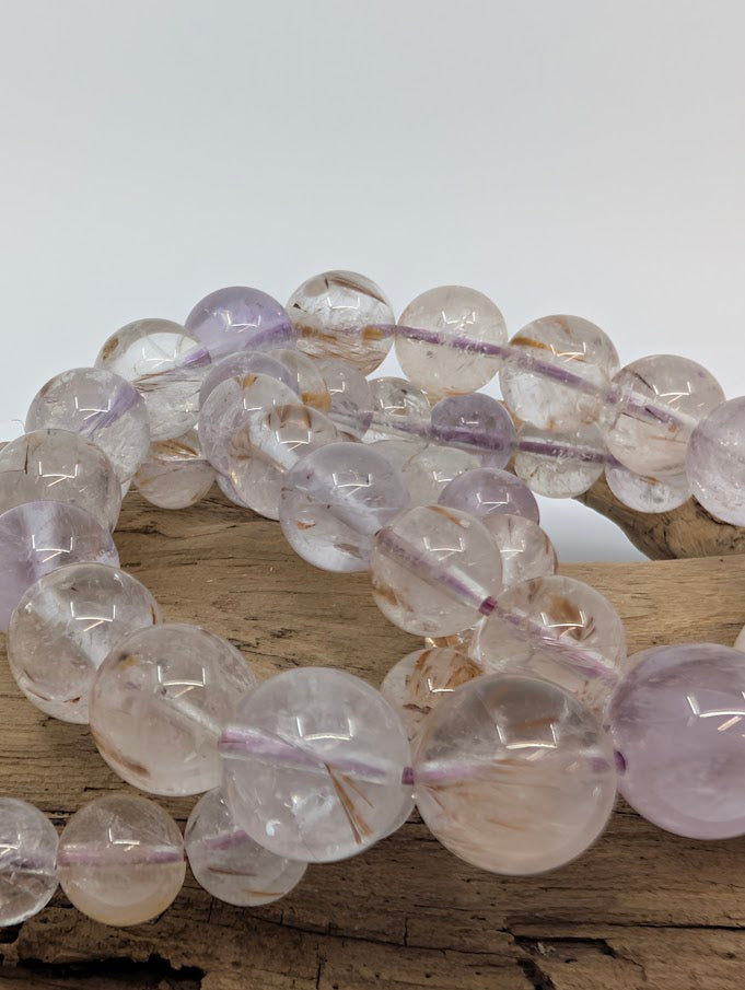 Close-up of Super Seven bracelet showing inclusions of rutile and amethyst