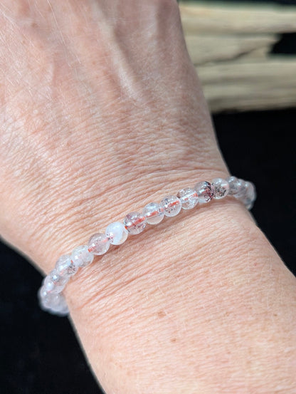 5mm Super Seven beaded bracelet worn on a wrist, demonstrating a delicate scale and clear quartz clarity.