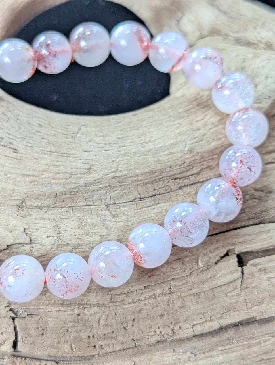 Macro detail shot of 8mm Congolese Super Seven beads showing clean quartz structure and vibrant internal inclusions.