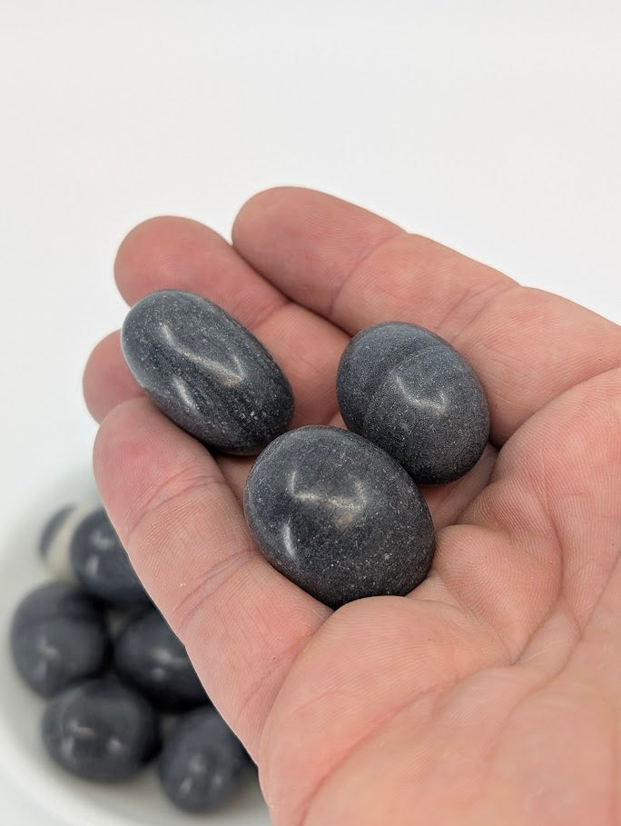 Tai Ji Jasper tumbled stones shown in hand for scale