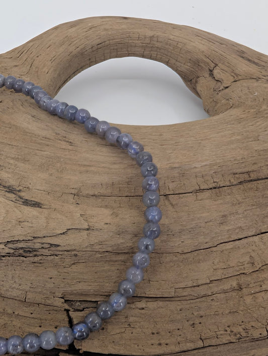 Close-up of tanzanite micro-bead bracelet showing pleochroic blue and violet tones