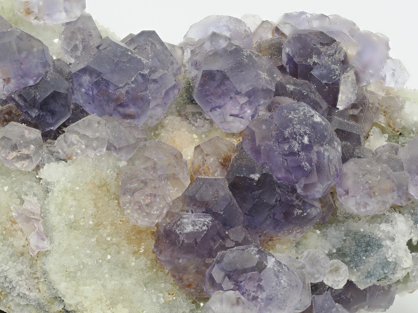 Close up detail of modified cubic Fluorite crystals with matte texture and deep indigo color.