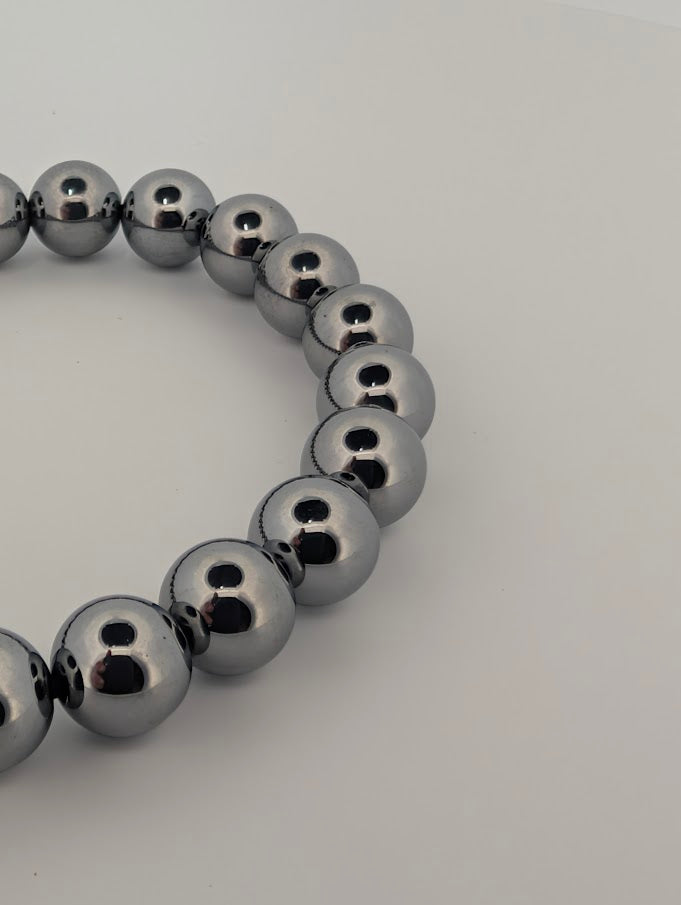 Polished 8MM Terahertz bracelet beads reflecting light