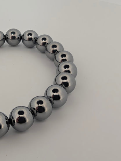 Polished 8MM Terahertz bracelet beads reflecting light