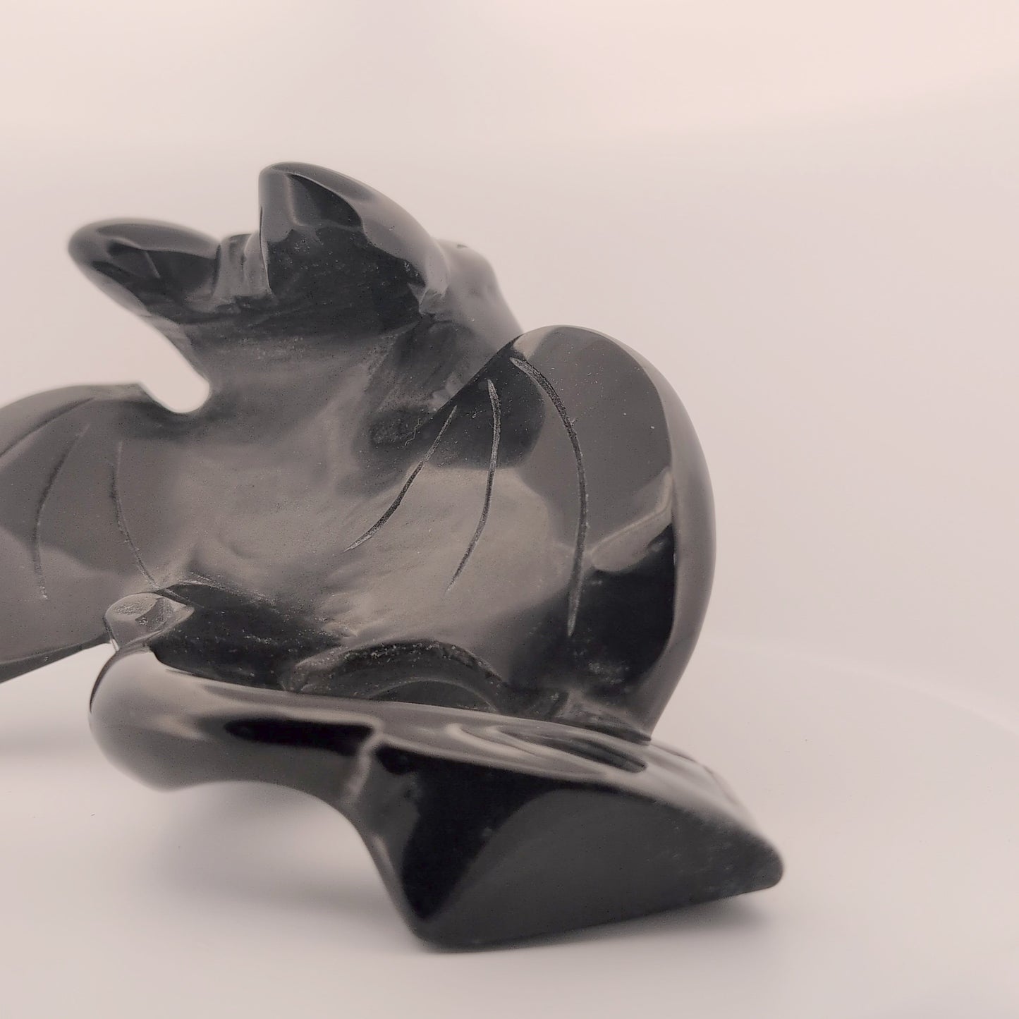 Rear view of Black Obsidian Toothless carving, polished tail and wings