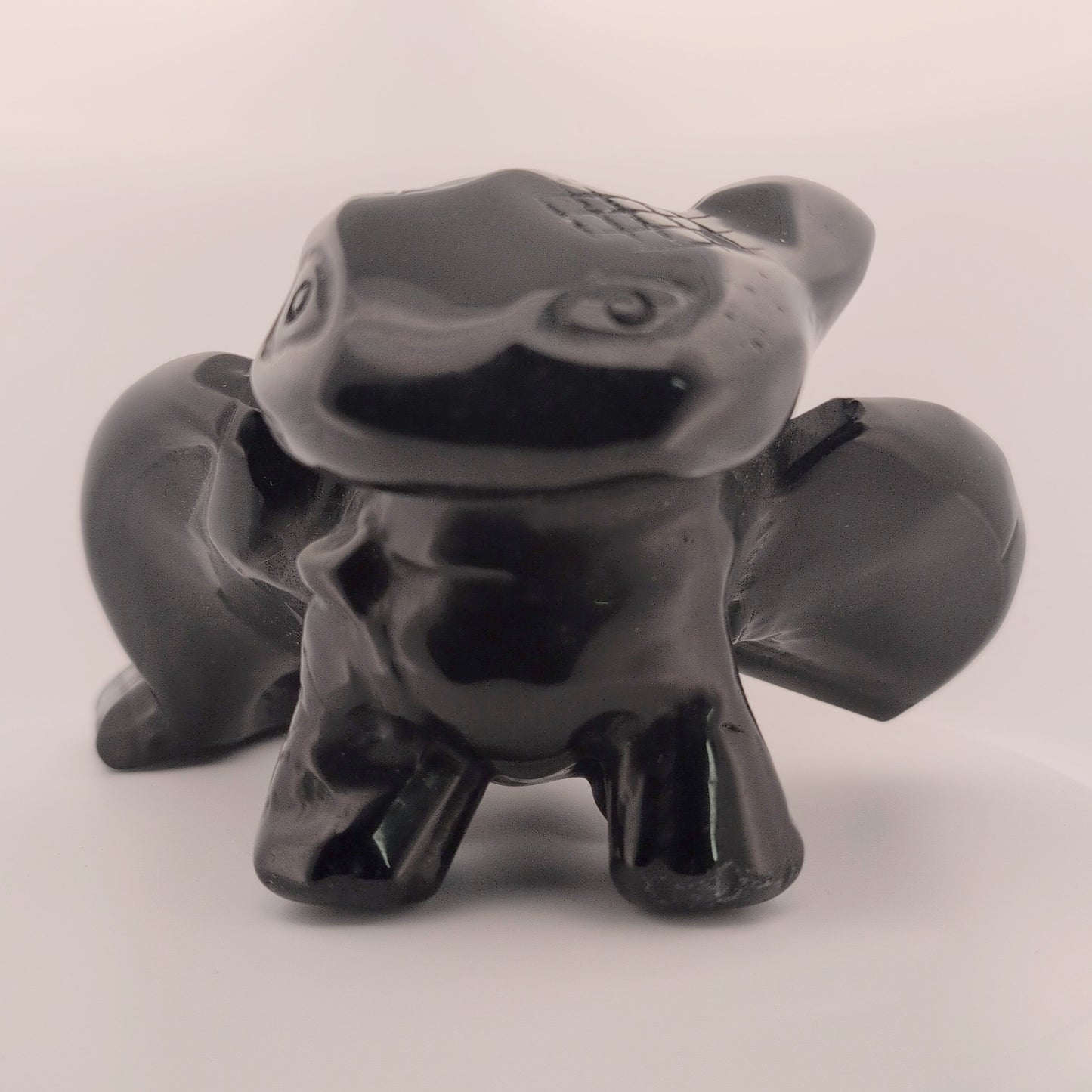 Black Obsidian Toothless dragon carving, front view with glossy polish