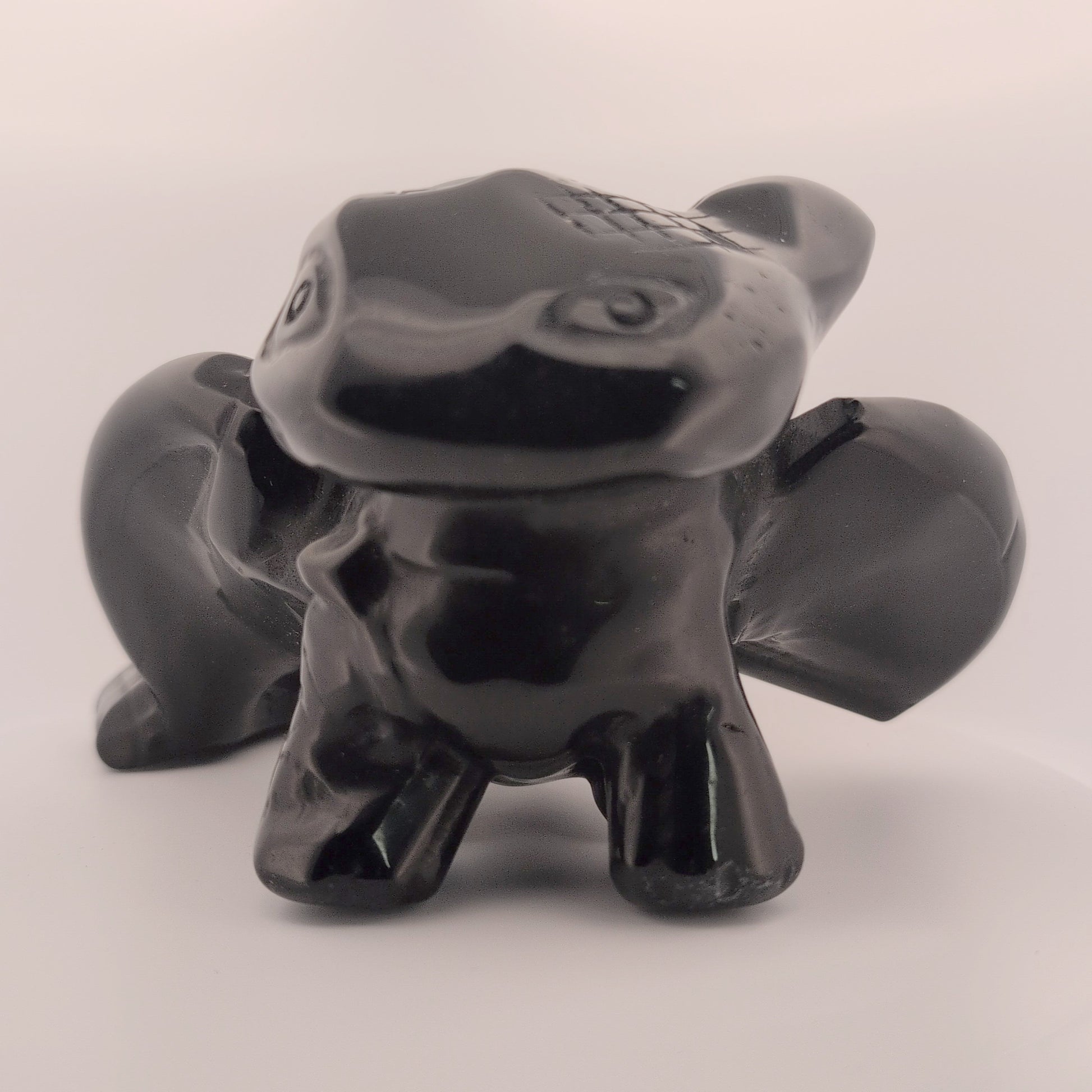 Black Obsidian Toothless dragon carving, front view with glossy polish