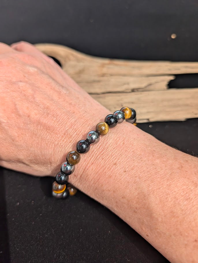 Natural sunlight on an 8mm Triple Protection mixed stone stretch bracelet worn on a wrist.