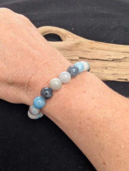 8mm polished Trolleite beaded stretch bracelet worn on a wrist for size scale.