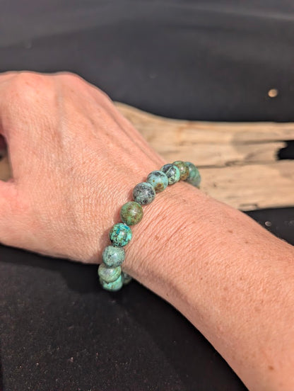 8mm turquoise beaded stretch bracelet worn on a wrist to demonstrate scale and fit.