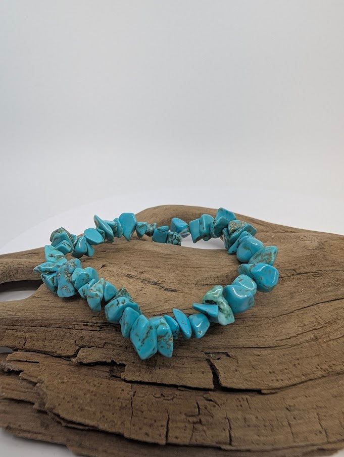 Turquoise chip bracelet displayed on wood background