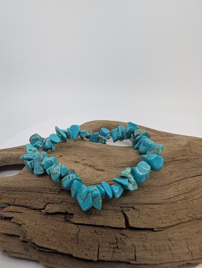 Turquoise chip bracelet displayed on wood background