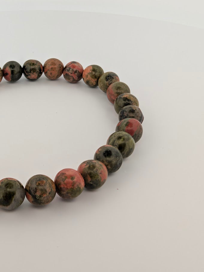 Close-up of polished 6MM Unakite beads