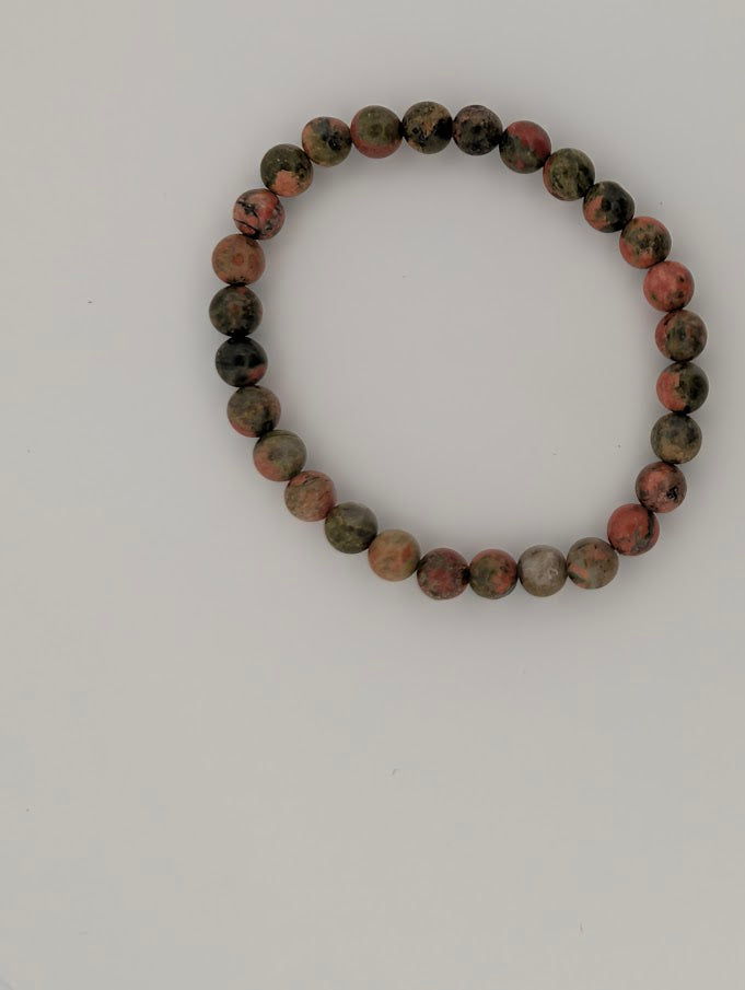 Top view of 6MM Unakite bracelet with pink and green beads
