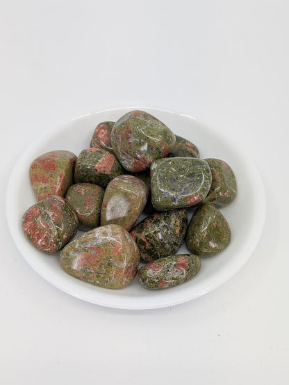 A-grade Unakite tumbled stones displayed in bowl showing green and pink patterning