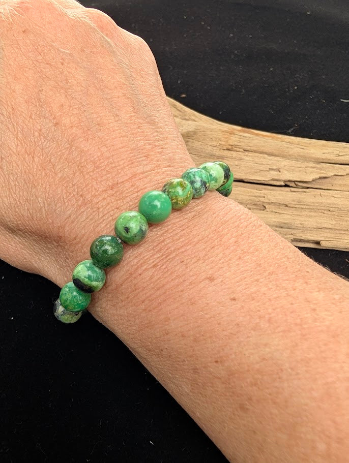 8mm polished Variscite beaded stretch bracelet worn on a wrist for size scale.