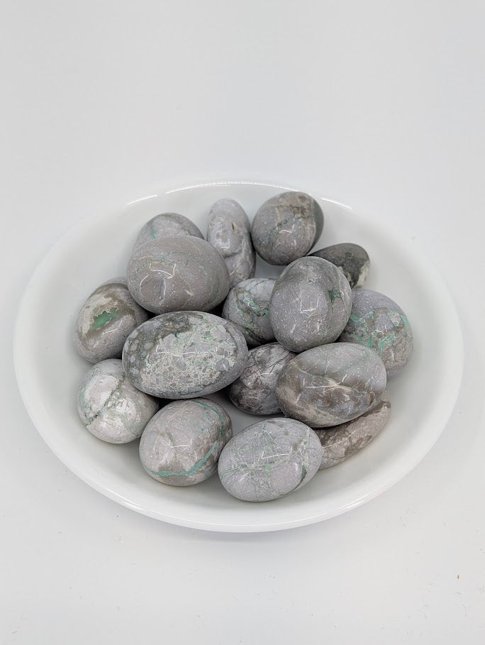 AA-grade Variscite tumbled stones displayed in bowl showing green and gray veining