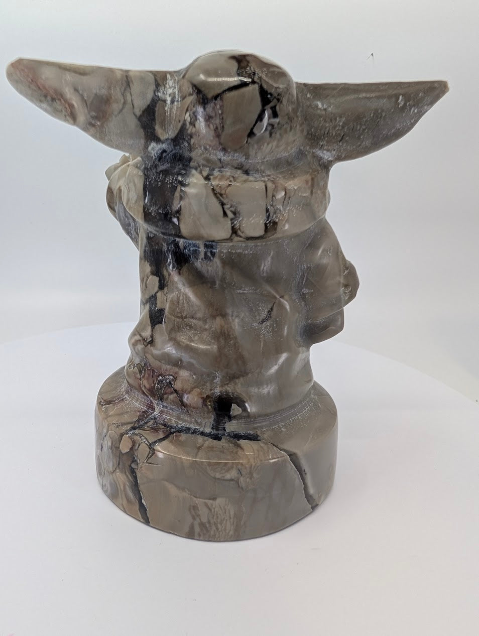 Left angle view showing robe folds and brecciated pattern in volcano agate Gorgu carving