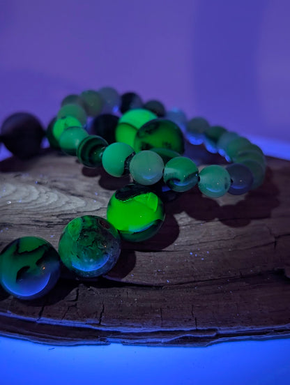 Volcano Agate bracelet glowing vivid green under UV light
