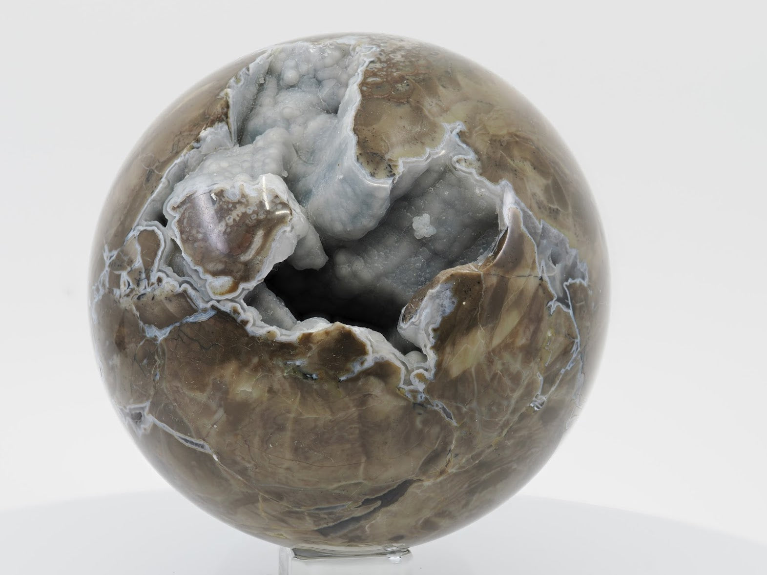 104mm Volcano Agate sphere from Madagascar featuring a large open vug with blue-grey botryoidal chalcedony.