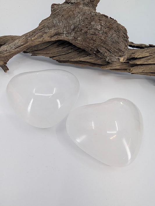 Pair of White Calcite hearts showing milky translucency and waxy luster.