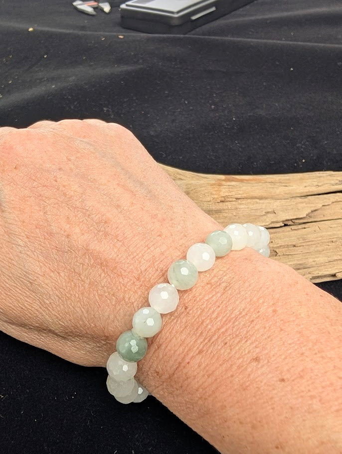 8mm faceted White Jade beaded stretch bracelet worn on a wrist for size scale.