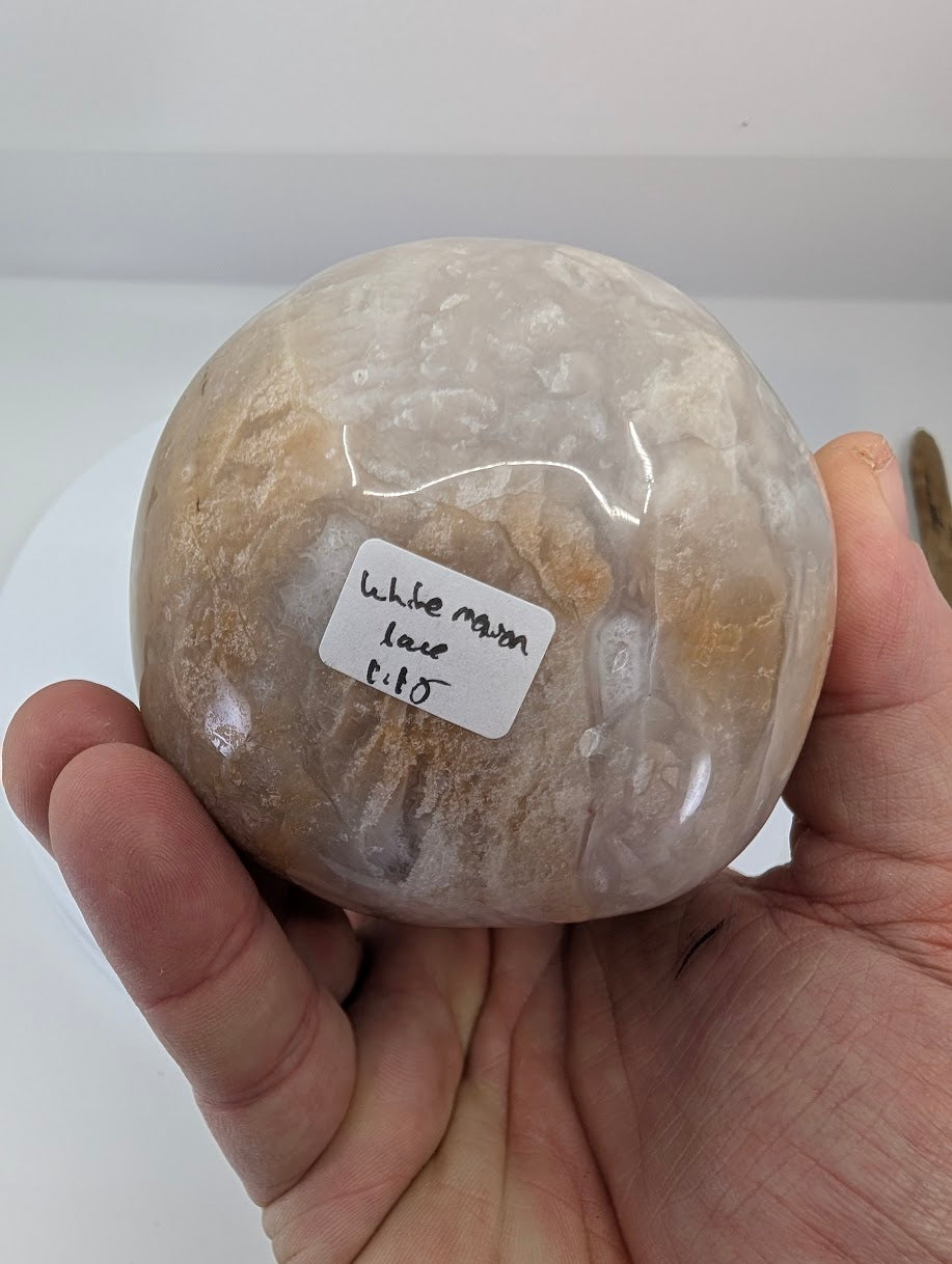 Bottom view of white Mexican lace agate egg showing swirling lace patterns