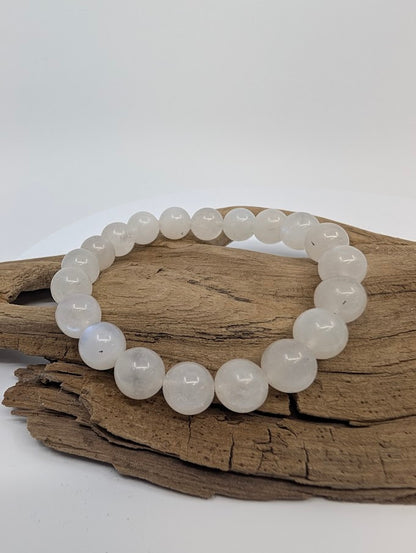 8MM White Moonstone bracelet displayed on wood