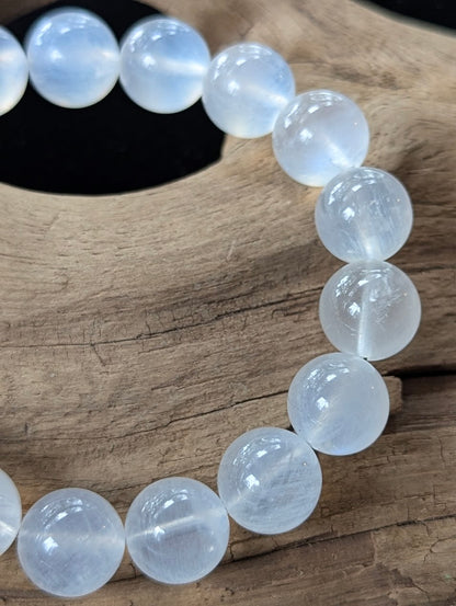 Detailed macro view of 11mm Sri Lankan White Moonstone beads, emphasizing their high translucency and bright optical sheen.