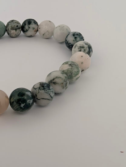 Detailed bead shot highlighting white chalcedony with green inclusions