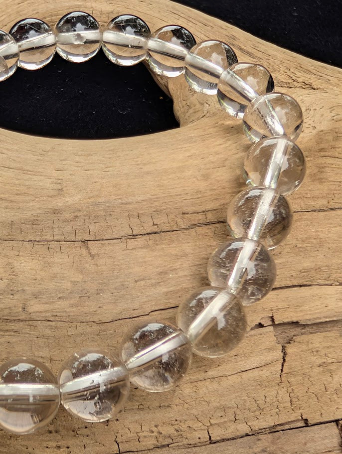 Macro close-up of 8mm AA-grade polished White Topaz beads from Sri Lanka highlighting the high-gloss finish and brilliant optical clarity.