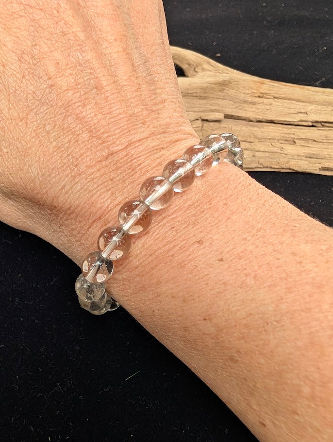 8mm AA-grade polished White Topaz beaded stretch bracelet from Sri Lanka worn on a wrist for size scale.