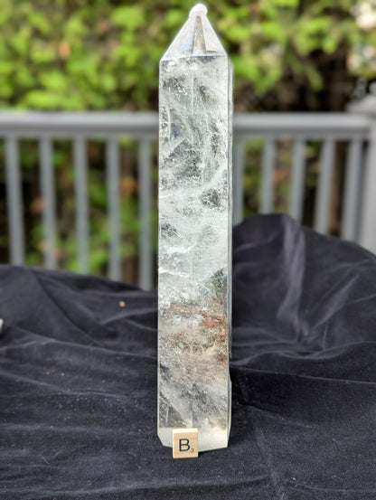 XL Garden Quartz Tower B standing upright with misty internal veils and earthy lower mineral inclusions