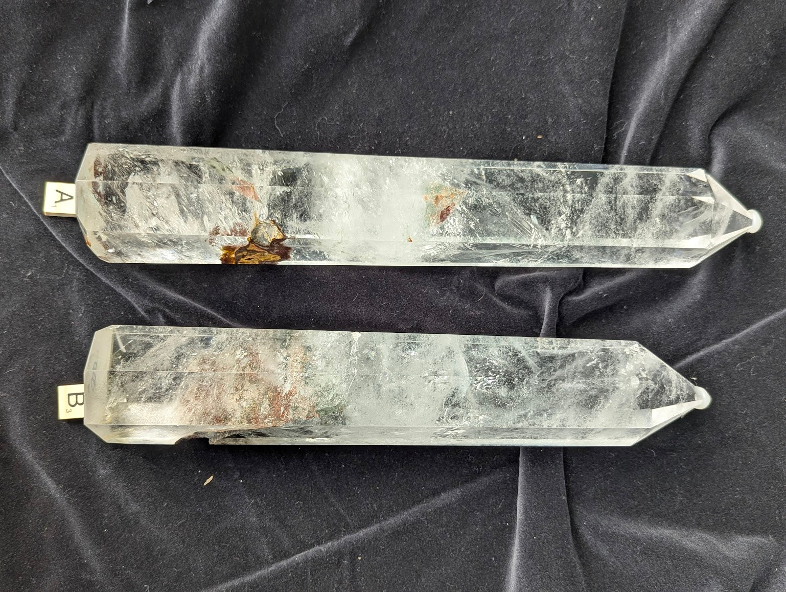 Garden Quartz Towers A and B comparison showing red-brown earthy inclusions and clear quartz veiling