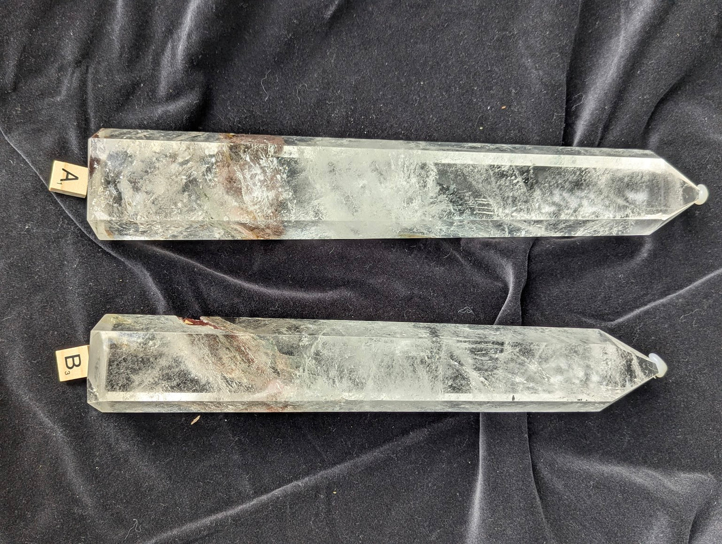 Large polished Garden Quartz Towers A and B displayed side by side with icy internal veils and scenic inclusions