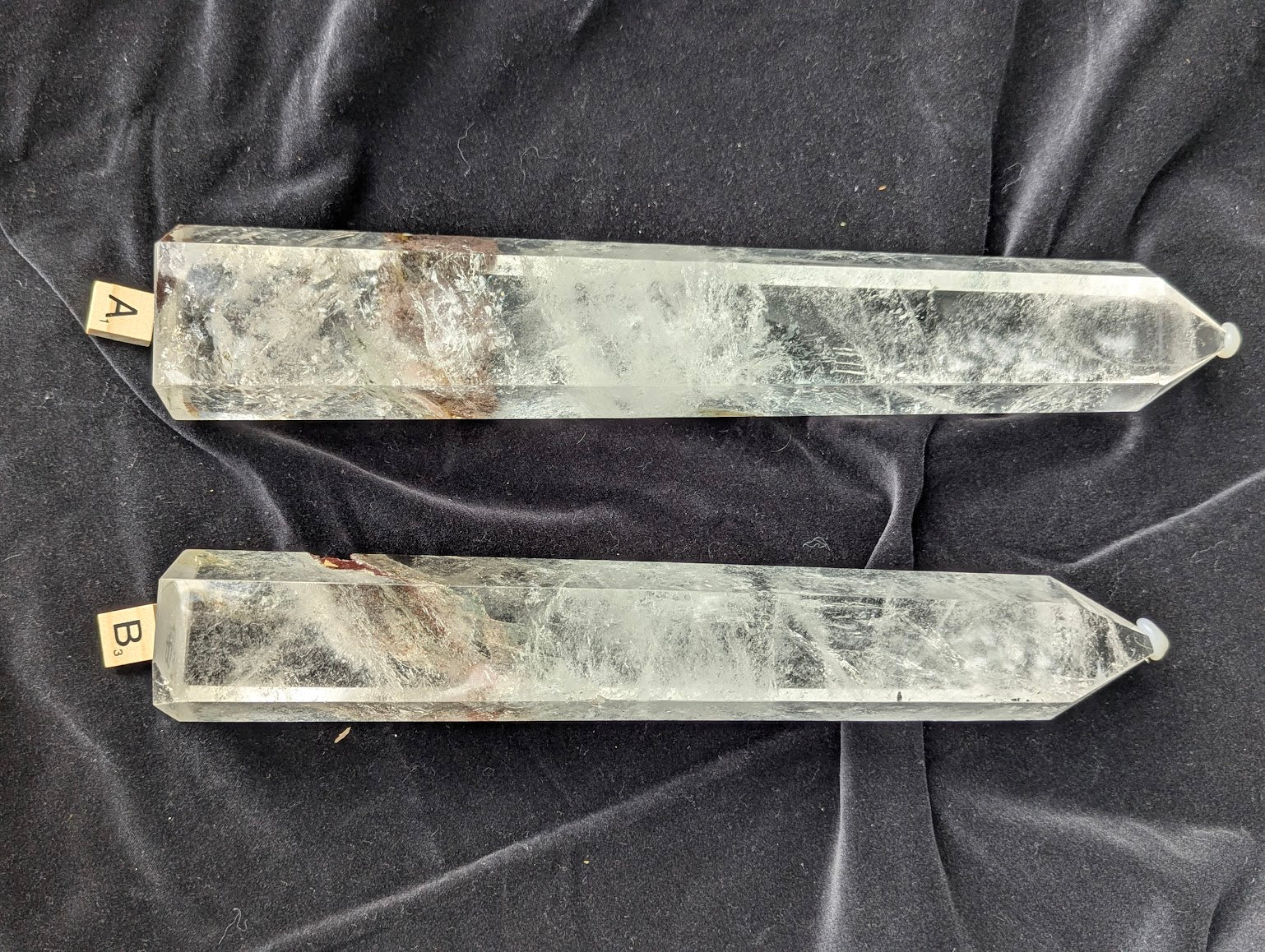 Large polished Garden Quartz Towers A and B displayed side by side with icy internal veils and scenic inclusions