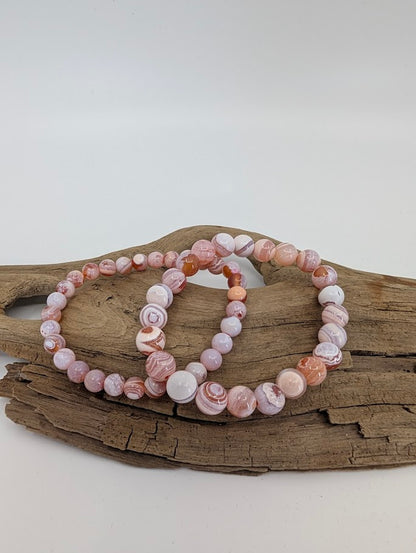 Yancheng banded agate bracelets in 6mm and 8mm showing soft pink and white banding