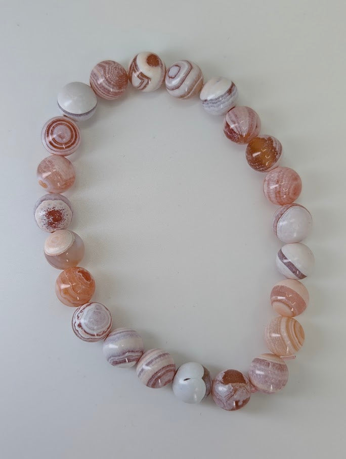 Top-down photo of Yancheng banded agate bracelet with smooth polish