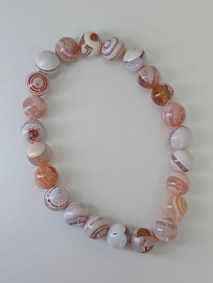 Top-down photo of Yancheng banded agate bracelet with smooth polish