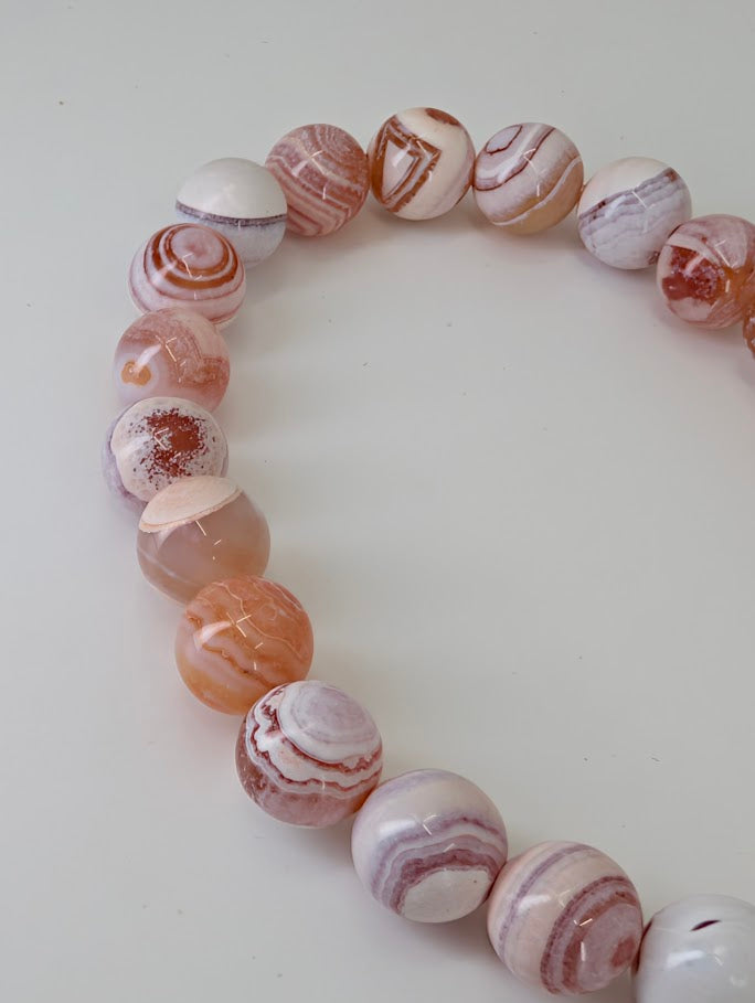 Detailed view showing natural eye patterns and pastel banding of Yancheng agate