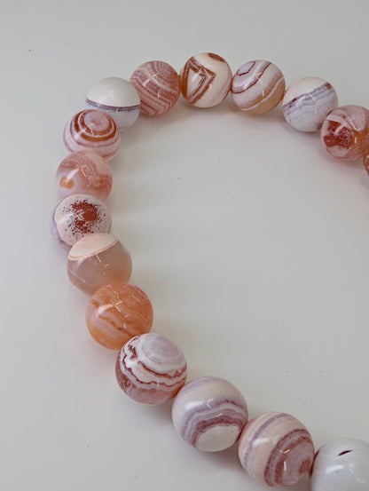 Detailed view showing natural eye patterns and pastel banding of Yancheng agate