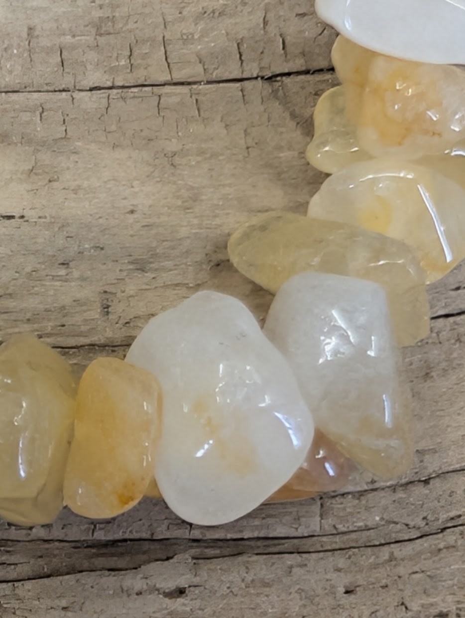 Macro shot of individual Yellow Aventurine chips highlighting the high-gloss finish and natural internal veils.