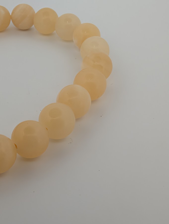 Side angle of Yellow Calcite bracelet showing bead polish