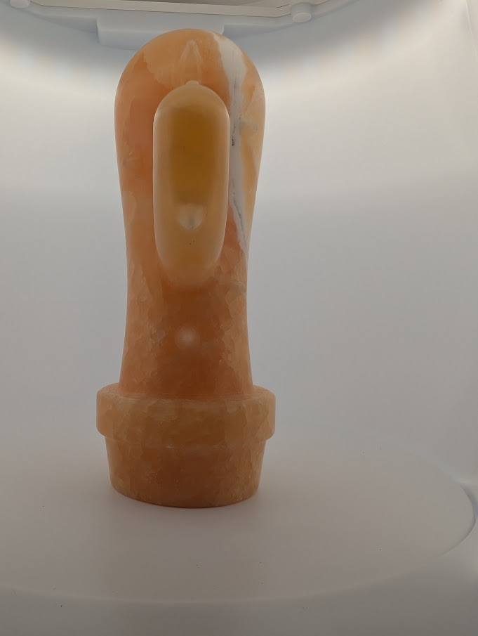 Lightbox side angle of Yellow Calcite cactus carving