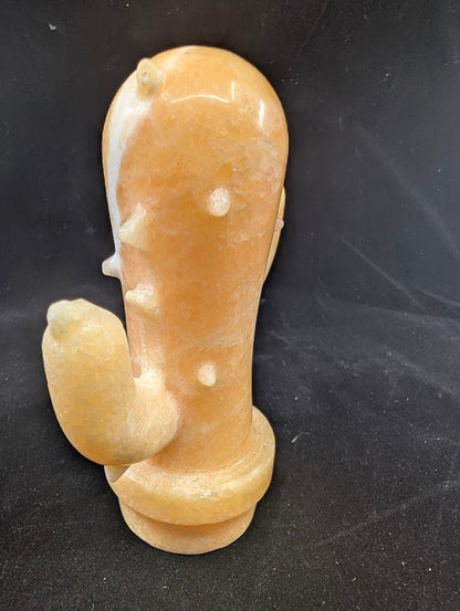 Side angle of Yellow Calcite cactus carving showing polished details