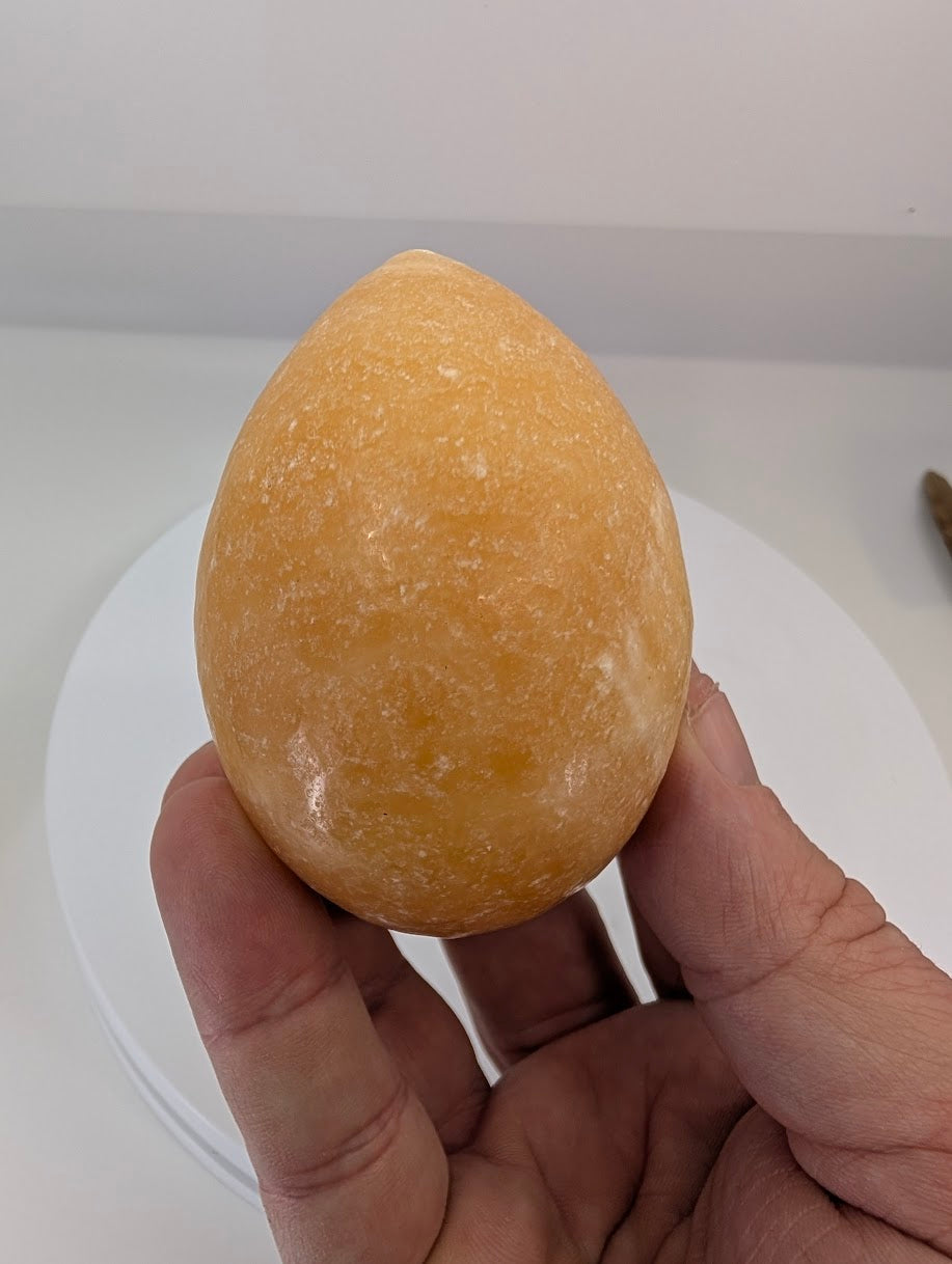 Group of polished yellow calcite eggs showing natural variation in color and patterning