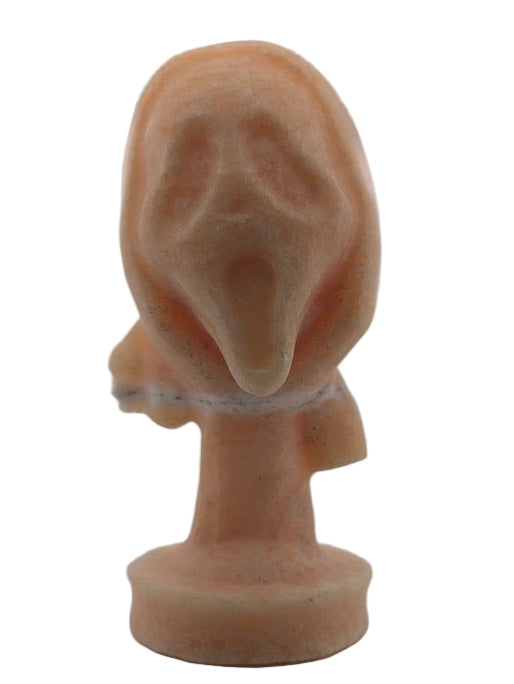 Front view of Yellow Calcite “The Scream” crystal carving, 6 x 3 in, 750g