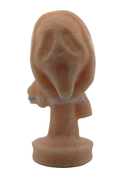 Front view of Yellow Calcite “The Scream” crystal carving, 6 x 3 in, 750g